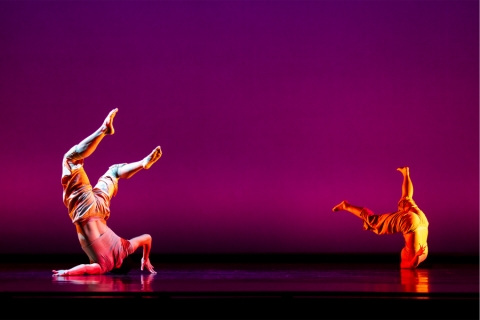 Dancer on stage flipping head over heels