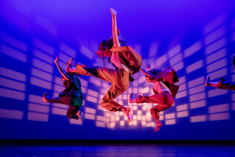 Dancer on stage mid-jump