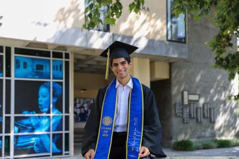 Person in grad regalia in plaza