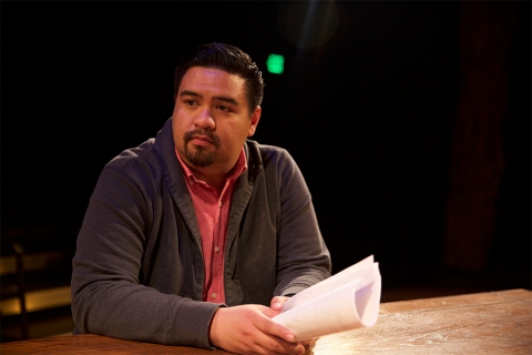 Jeffrey Lo sitting at table with script in hand