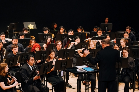 View of wind ensemble on stage with conductor