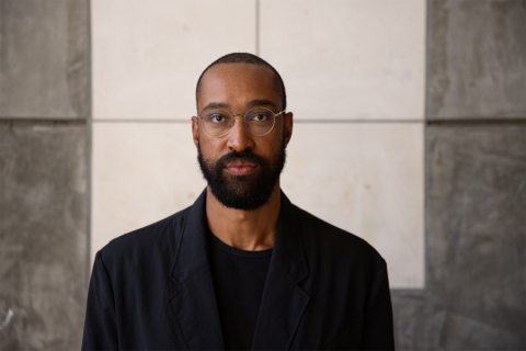 Person in glasses in front of gray background
